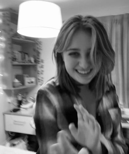 A black and white photo of Alex smiling into the camera
